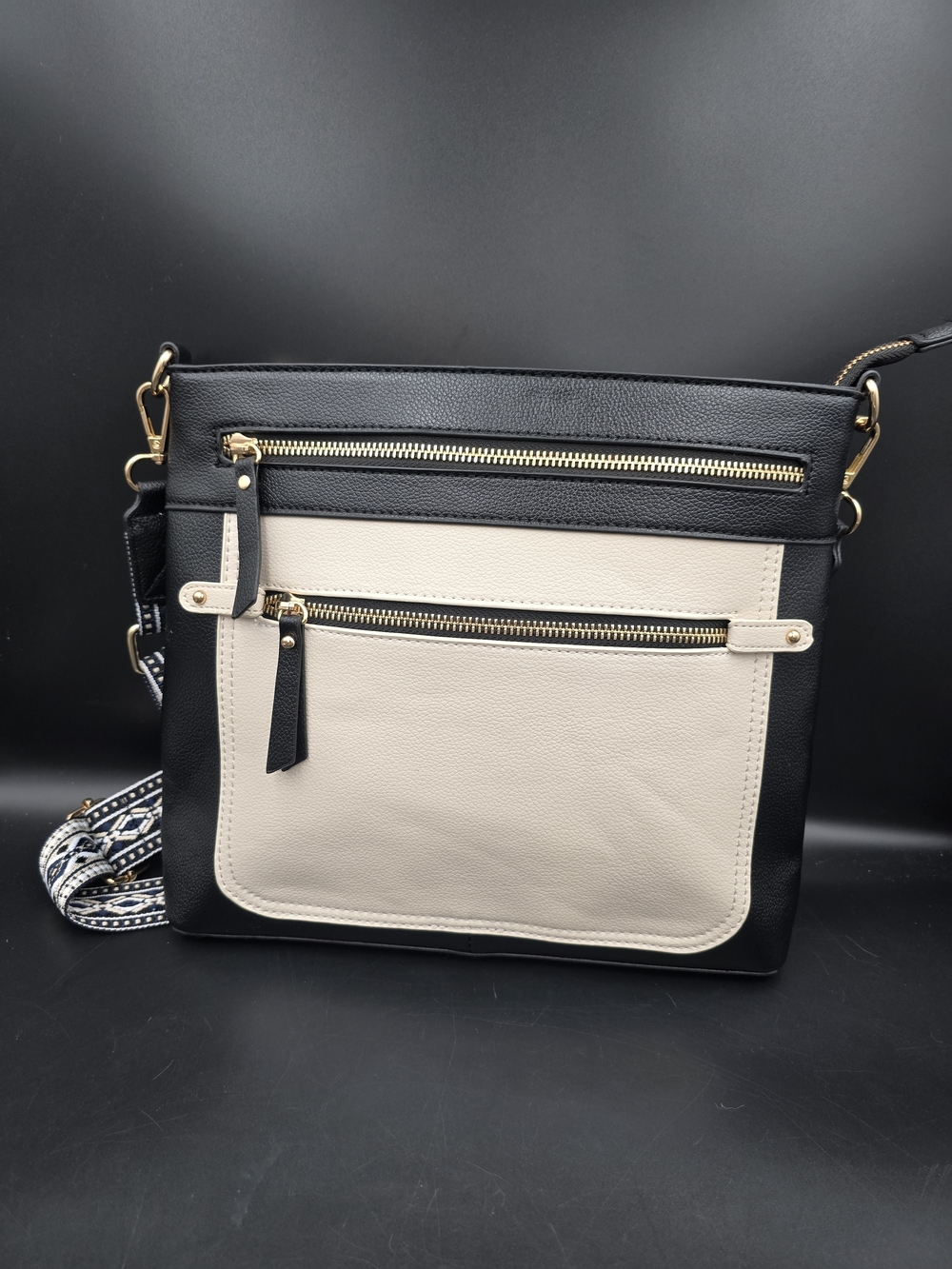 Two-Tone Black and Cream Crossbody Bag with Gold Zippers